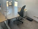 a desk with a chair and a computer on it