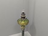 a glass lamp that is sitting on a white table