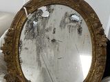 a mirror that is sitting on a bed in a room