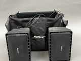 two speakers and a bag are sitting next to each other