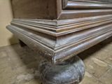a close up view of a wooden bench with a metal base
