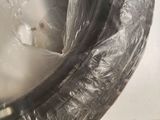 a close up of a toilet with a plastic cover on it