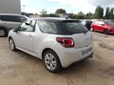 a small white car that is parked in a parking lot