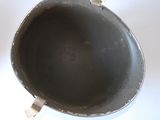 an old frying pan sitting on a white table