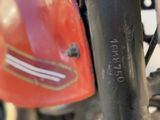 a close up of a motorcycle with a red helmet on it