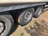 a flat bed trailer with a flat bed on the side of it