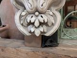 a statue of a flower on a wooden block