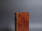 an old book sitting on top of a gray surface
