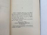 an open book on a white surface with a black border