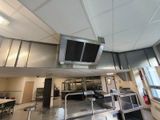 a view of a kitchen from the inside of a building
