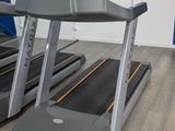 two tread machines that are on the floor in the room