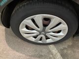 a close up of a tire on a car in a parking lot