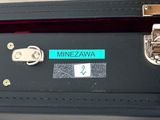a black suitcase with a label on it that says minezzawa