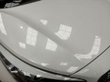 a close up of the hood of a white car