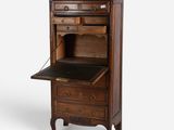an old wooden cabinet with drawers and a black top