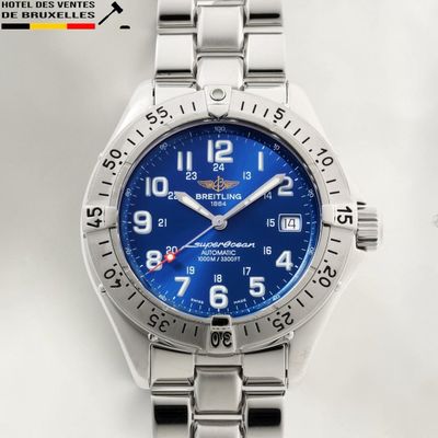 a close up of a wrist watch with a blue dial