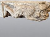 an image of a stone sculpture of a man laying on a bench