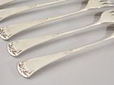 six silver plated forks and spoons are lined up on a table
