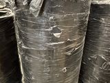 many rolls of black plastic sitting on a pallet