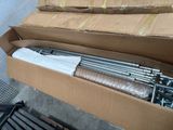 a cardboard box with a bunch of metal rods inside of it