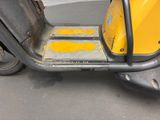 a scooter that is parked on the side of the street