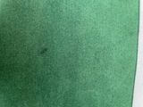 a close up of a green tie on a white background