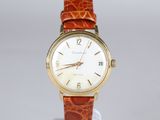a close up of a wrist watch on a stand