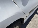 a close up of a car ' s front bumper with a denting on it