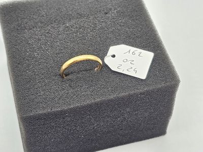 a close up of a gold ring with a price tag on it