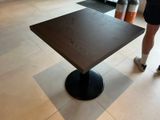 a woman standing next to a table in a room