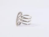 a close up of a silver ring on a white surface