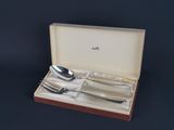 a set of silverware in a box on a table