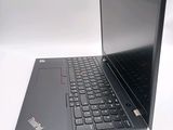 a laptop with a black keyboard sitting on a white surface