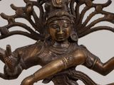 a bronze statue of a woman holding a bird