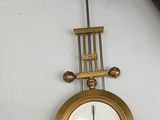 a clock hanging on the wall next to a pair of shoes