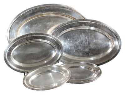 several silver plates are stacked on top of each other on a white surface