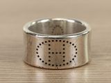 a close up of a silver ring on a wooden table