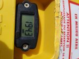 a yellow fire hydrant with a digital clock on it
