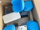 a cardboard box with blue sponges and a cell phone in it