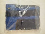 a blue and black blanket wrapped in plastic on a bed
