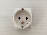 an overhead view of a white electrical outlet on a white wall