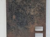 an old rusted metal plate with holes and holes on it