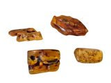 four pieces of brown and black stone on a white surface