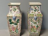 two vases sitting next to each other on a table
