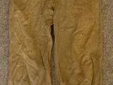 an old pair of pants sitting on a carpeted floor