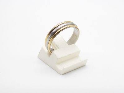 a close up of a ring on top of a white block