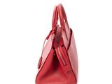red leather handbag with zippers on a white background