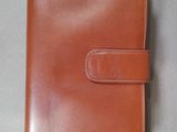 a brown leather wallet with a card holder on it