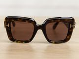 a pair of sunglasses sitting on top of a wooden table