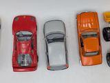 several toy cars are lined up in a row on a white surface